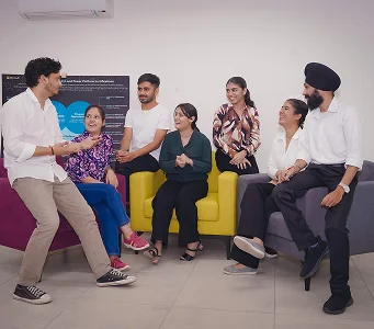 Defacto team members gathering in the office